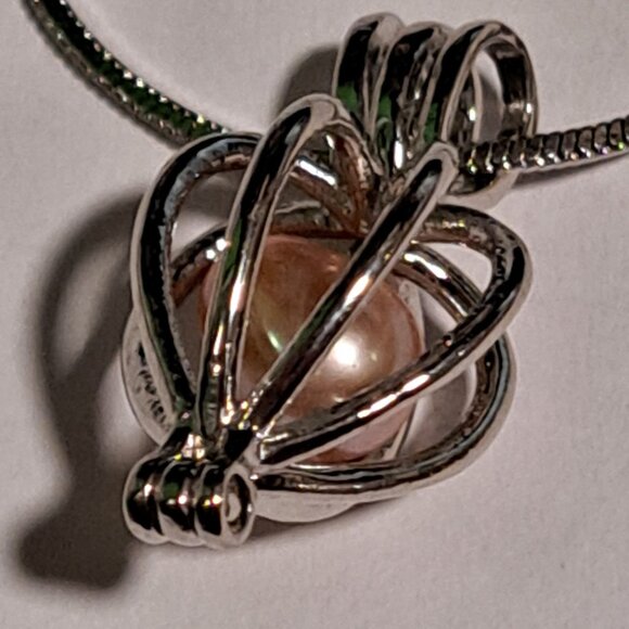 Jewelry - hinged pendant that opens to hold anything you want on a silver color chain